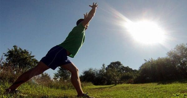 blog picture of a man stretching out in a field under the sun