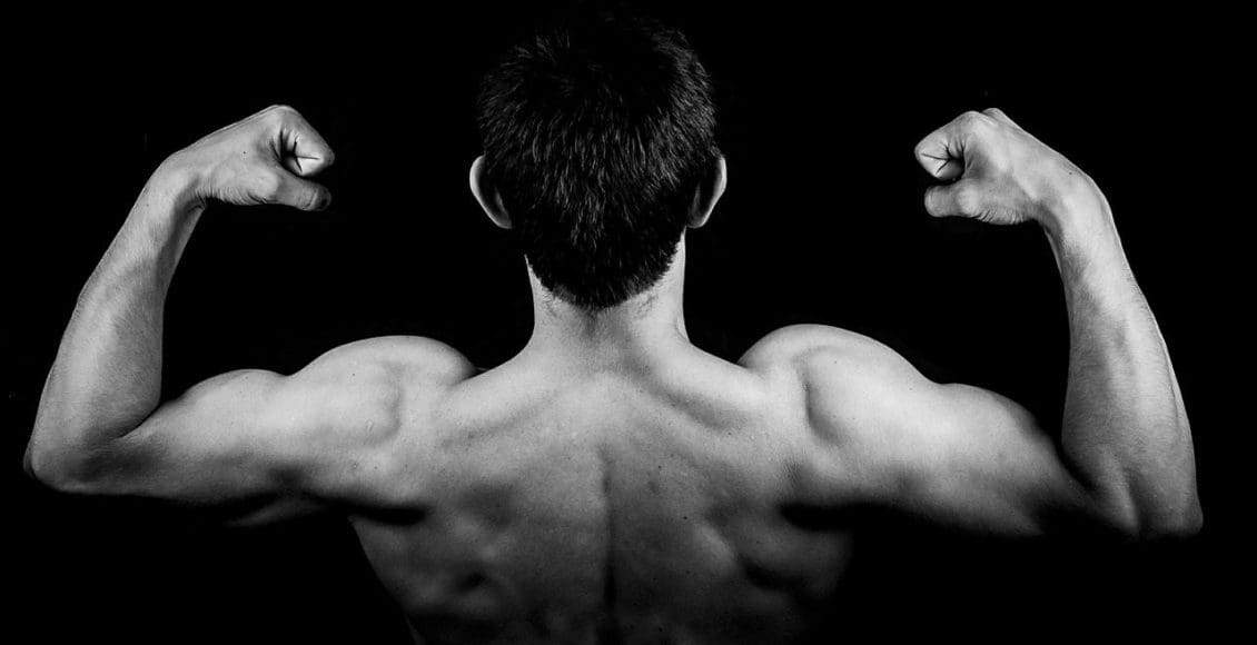 blog picture of man flexing muscles from the back
